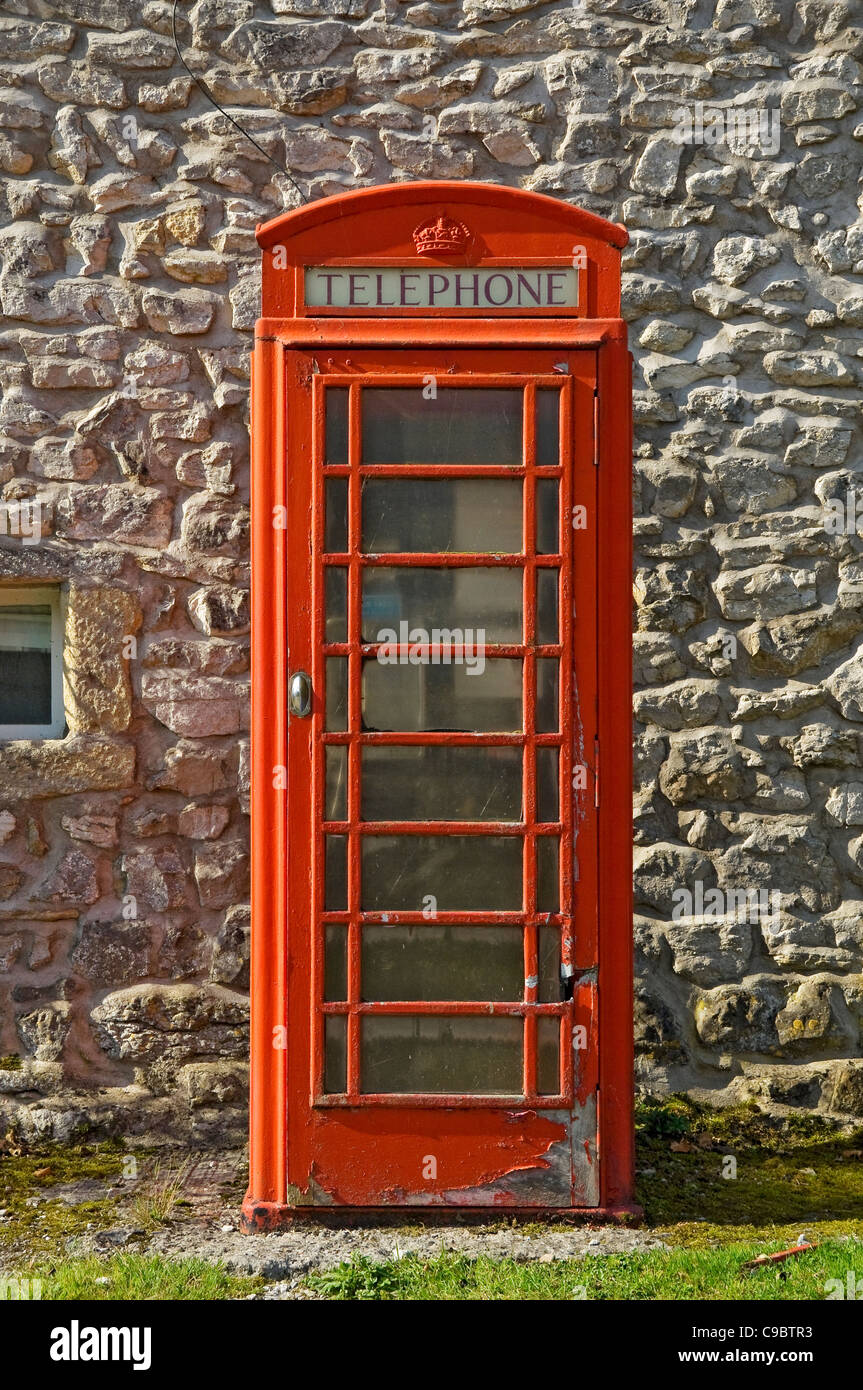Traditional English British red telephone phone box booth in village England UK United Kingdom GB Great Britain Stock Photo
