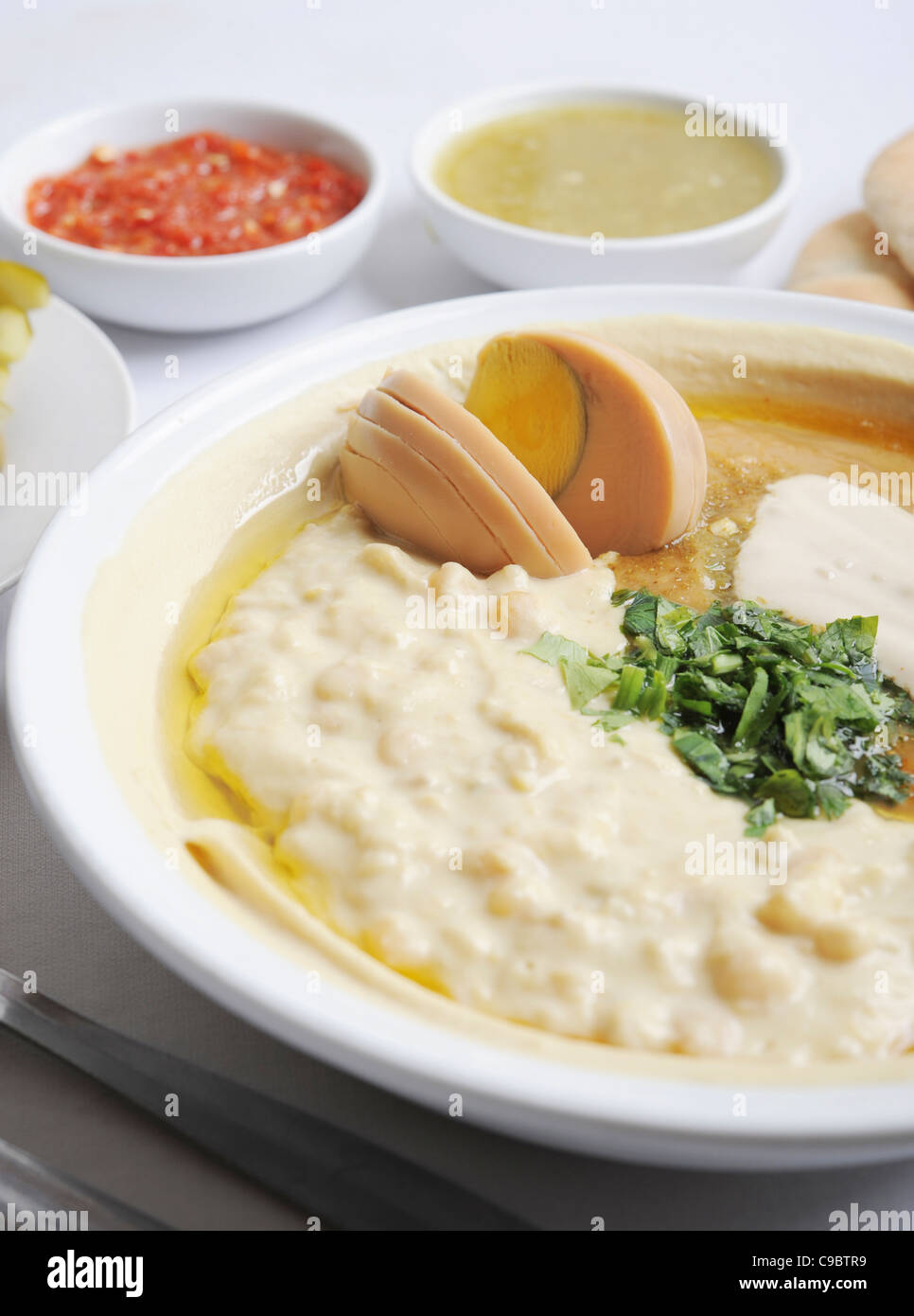 Hummus. A Levantine Arab dip or spread made from cooked, mashed chickpeas, blended with tahini, Stock Photo