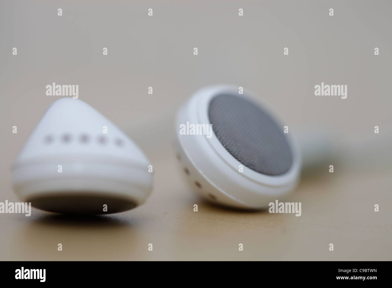 Modern and small earphones on a desk Stock Photo