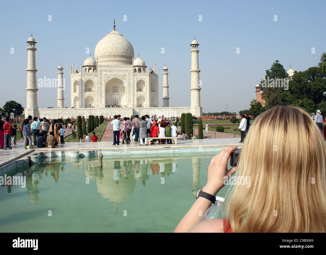 A tourist lady photographing the Taj Mahal in Agra , India Stock Photo