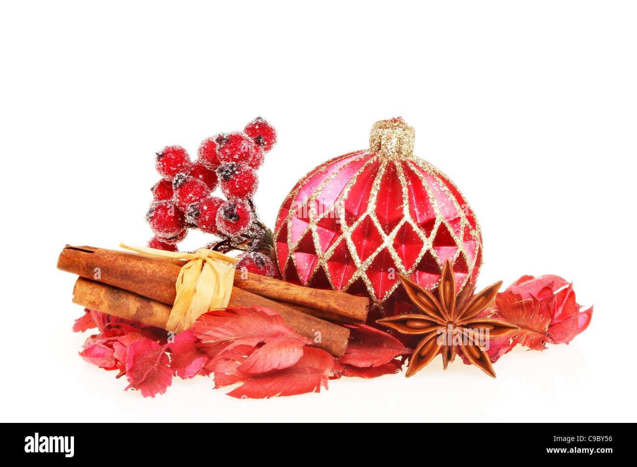 A Christmas theme, decorative bauble, potpourri, spices and a frosted berry decoration isolated on white Stock Photo