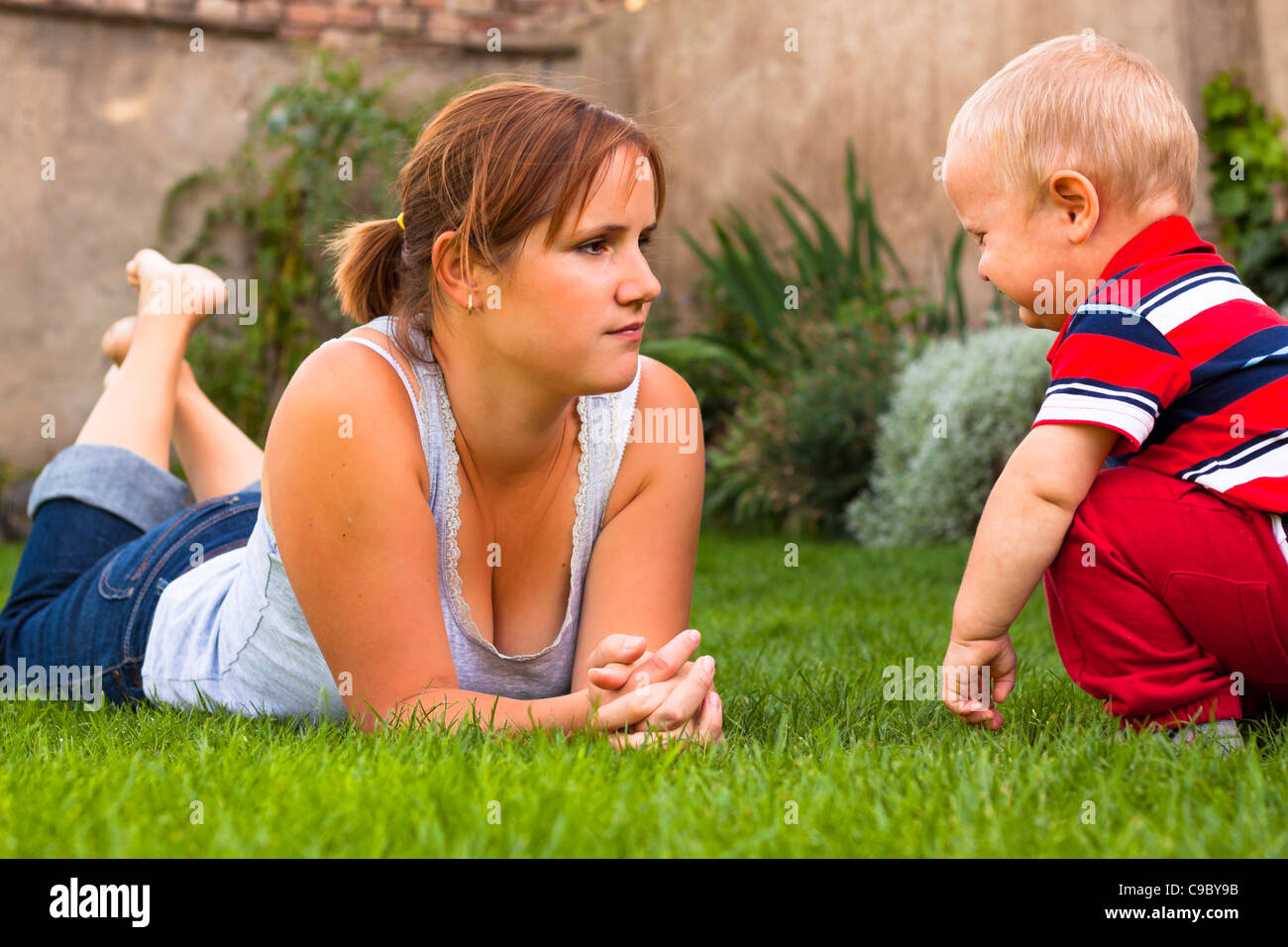 Mother with toddler serious moment in the garden Stock Photo - Alamy