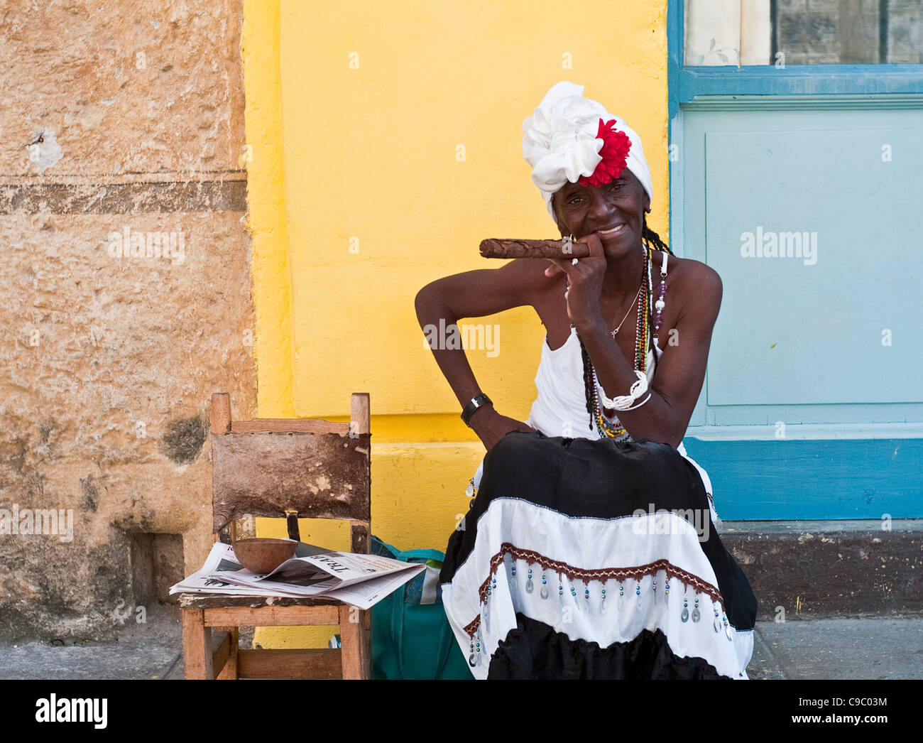 Cuba, Caribbean, Havana Old Town, Cigar Lady holding large cigar charges tourists $1 for a picture. Stock Photo