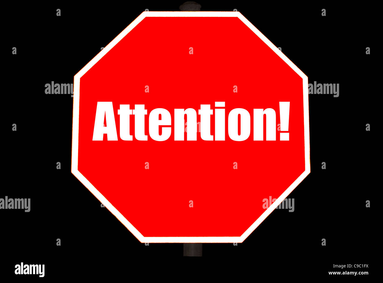 Attention Concept On A Bright Red Stop Sign Isolated On Black Stock Photo