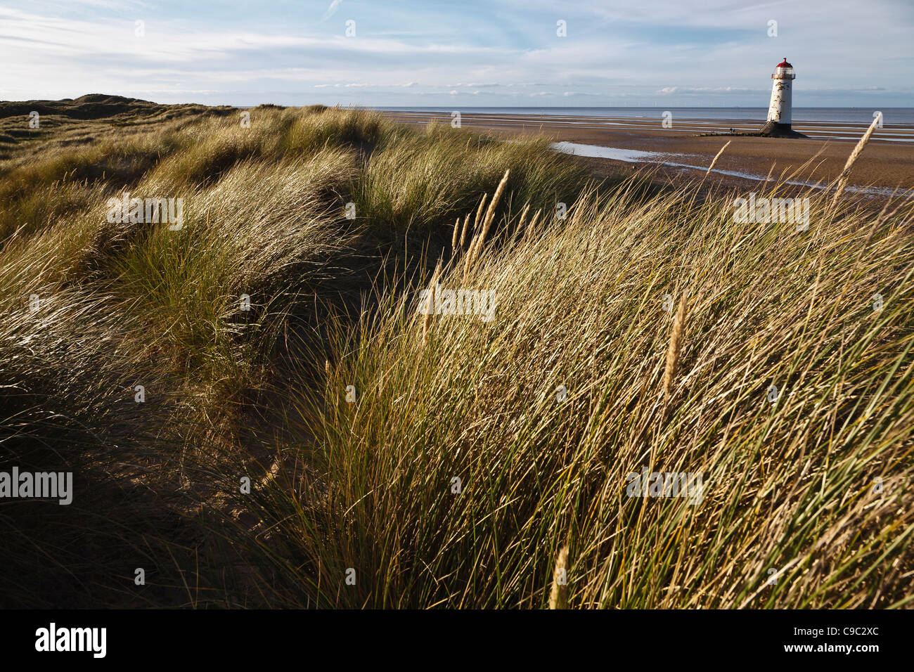 Sand dunes and the Point of Ayr Lighthouse, Talacre Beach, Flintshire, Wales Stock Photo