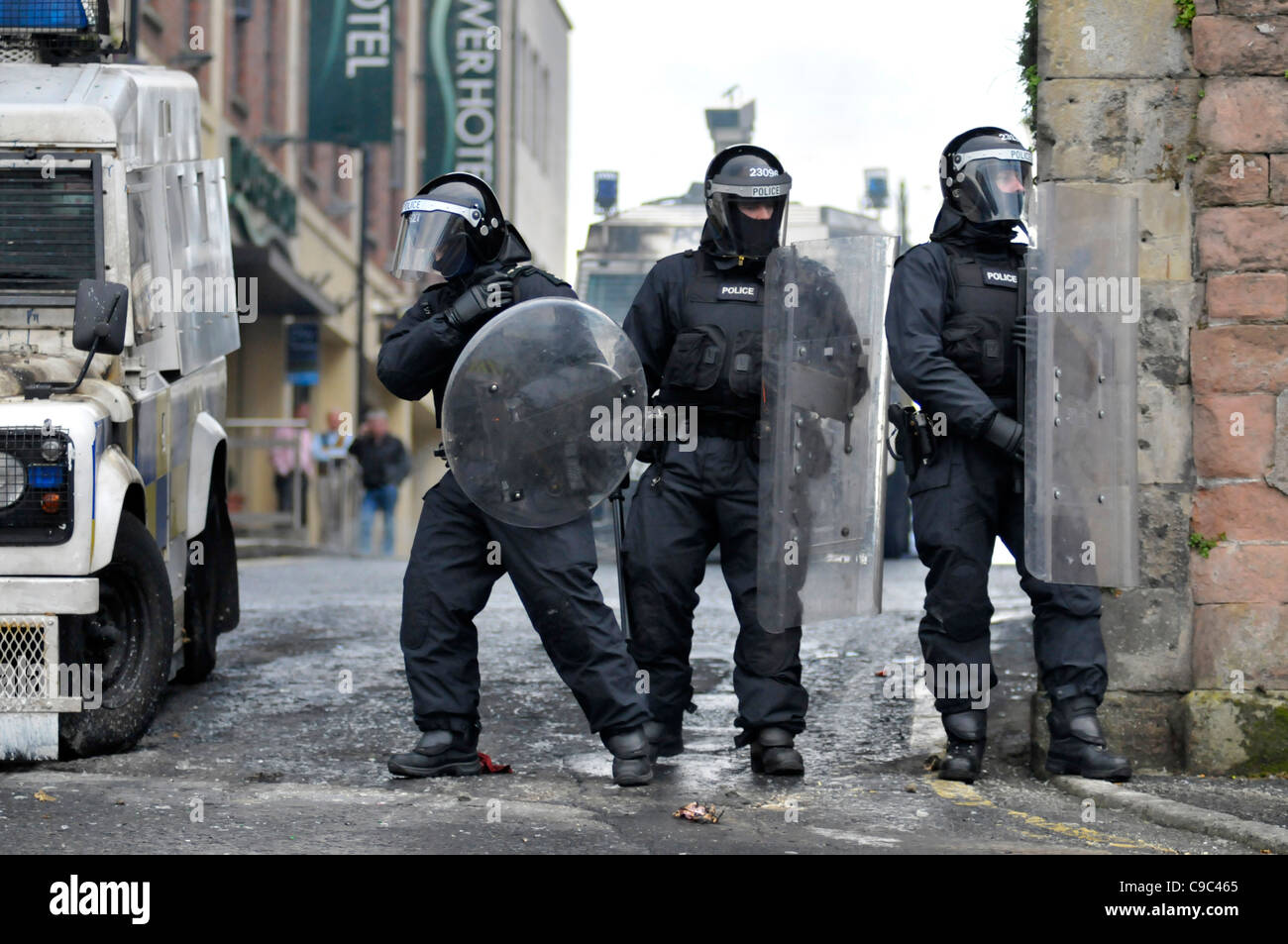 PSNI officers with riot shields and batons during disturbances in the Bogside, Londonderry, Northern Ireland. Stock Photo