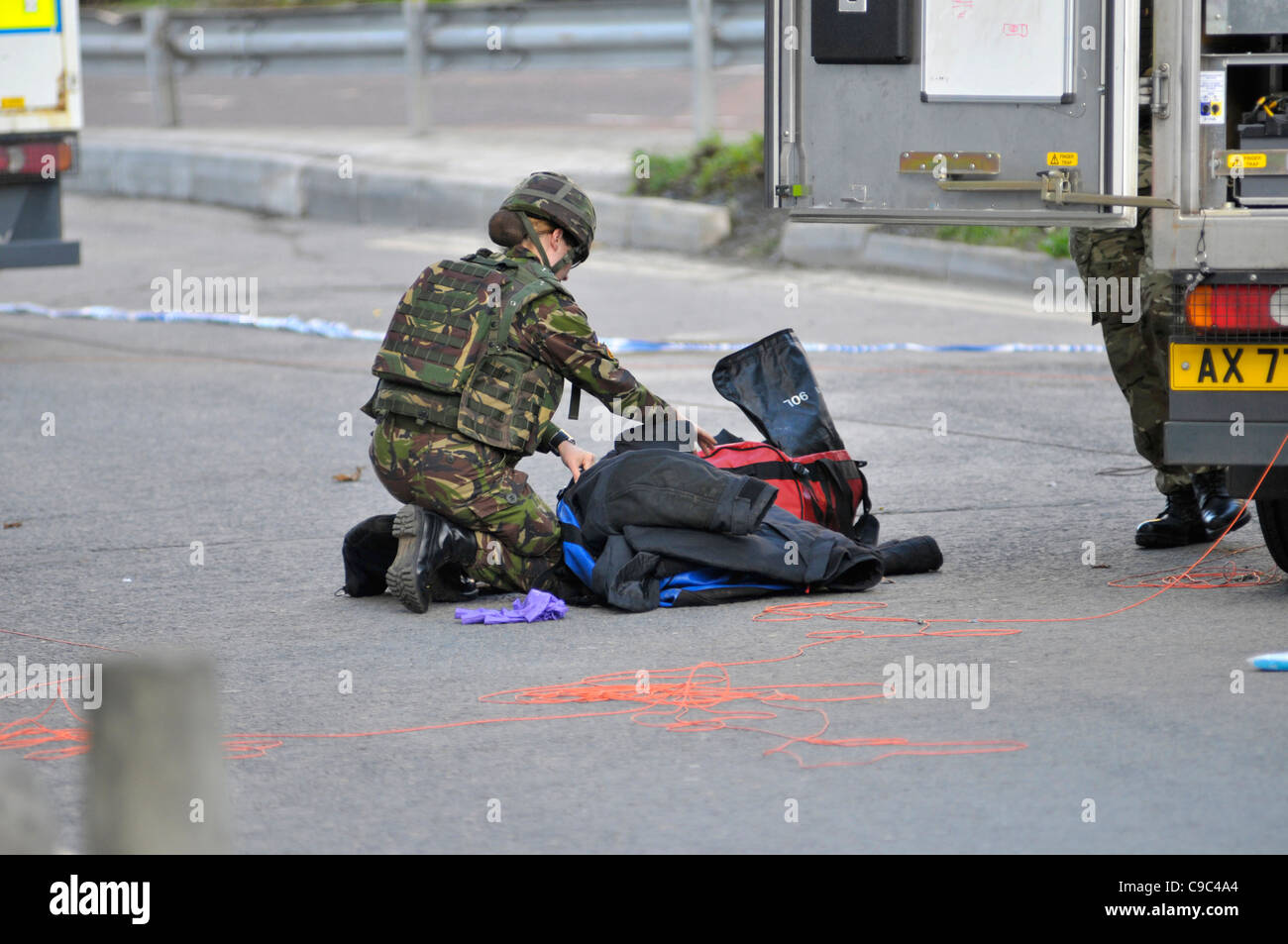 An female army technical officer returns at the scene of a suspicious package in Victoria car park, in Londonderry. Stock Photo