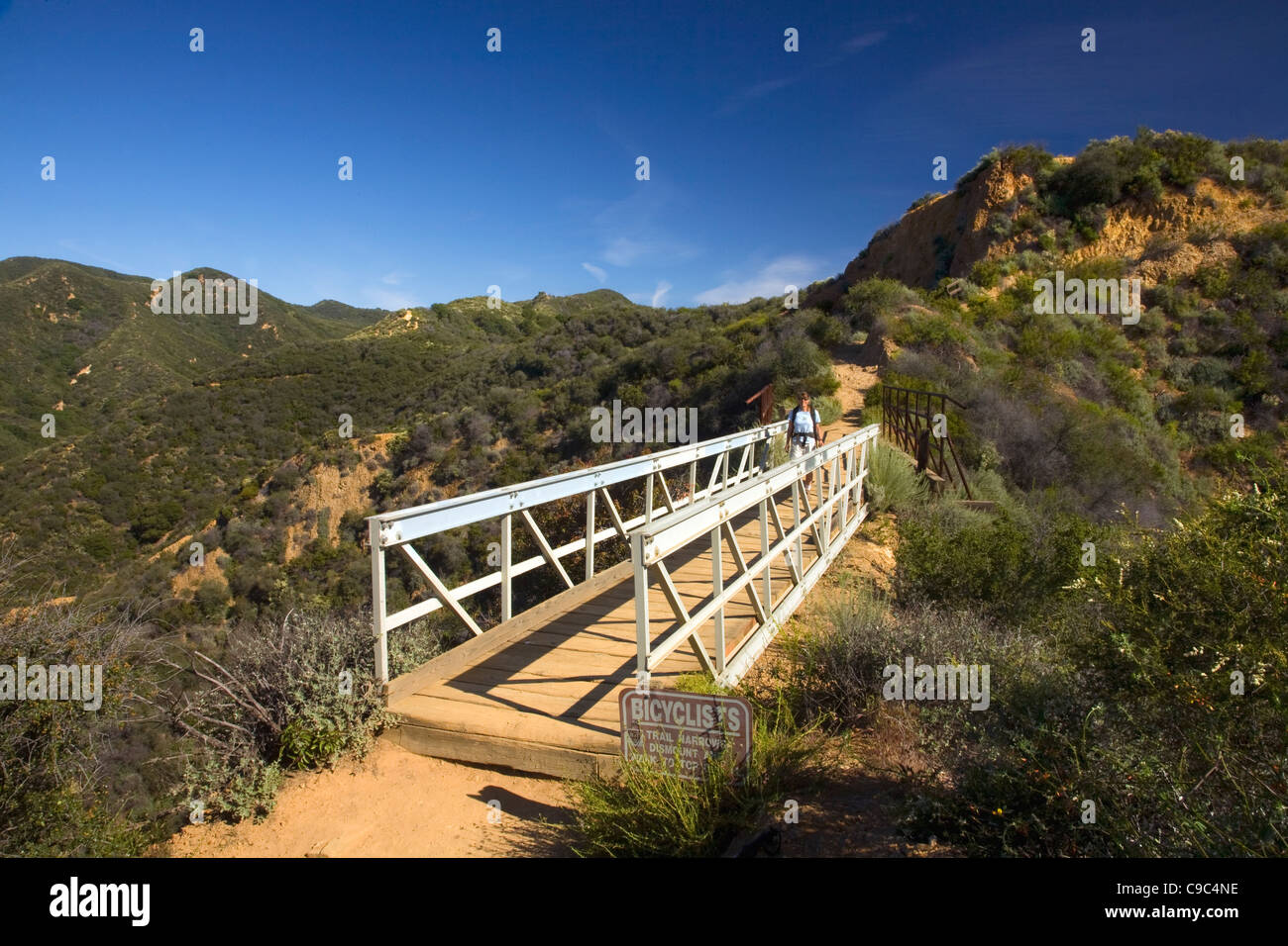 CALIFORNIA - Hiker on bridge on the Backbone Trail in the Topanga State Park section of the Santa Monica Mountains. Stock Photo