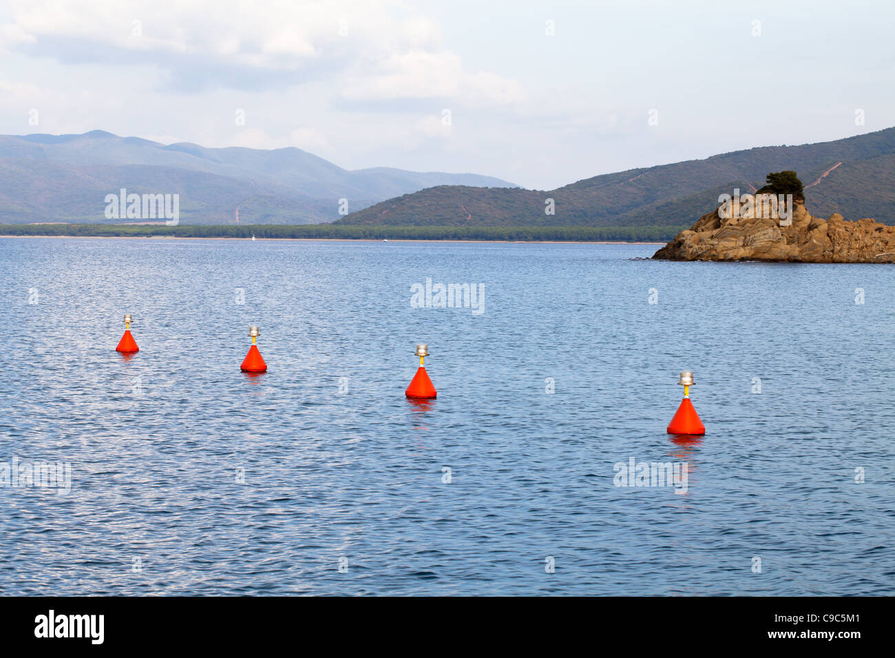 Red buoys in the sea to mark the entrance in the port, Punta Ala, Tuscany, Italy. Stock Photo