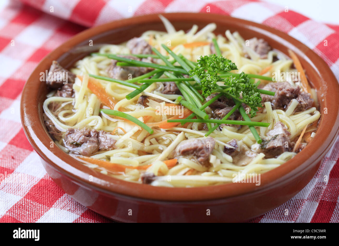 Bowl of beef soup with homemade noodles Stock Photo