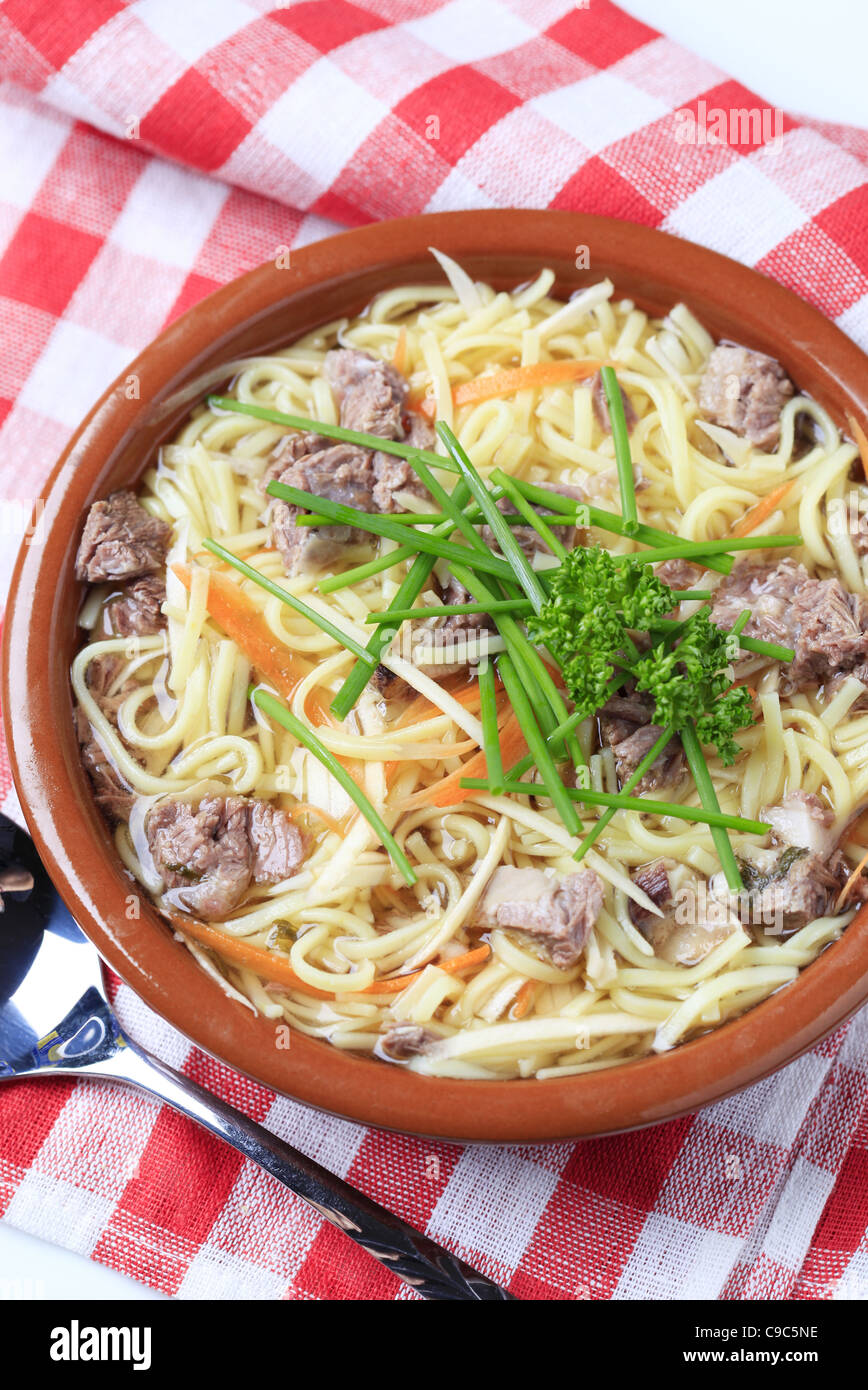 Bowl of beef soup with homemade noodles Stock Photo