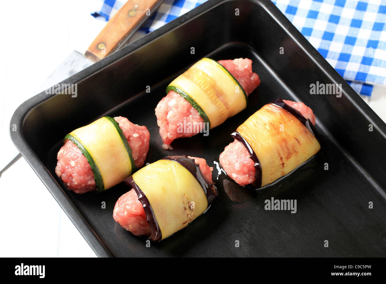 Minced meat wrapped in slices of eggplant and zucchini Stock Photo