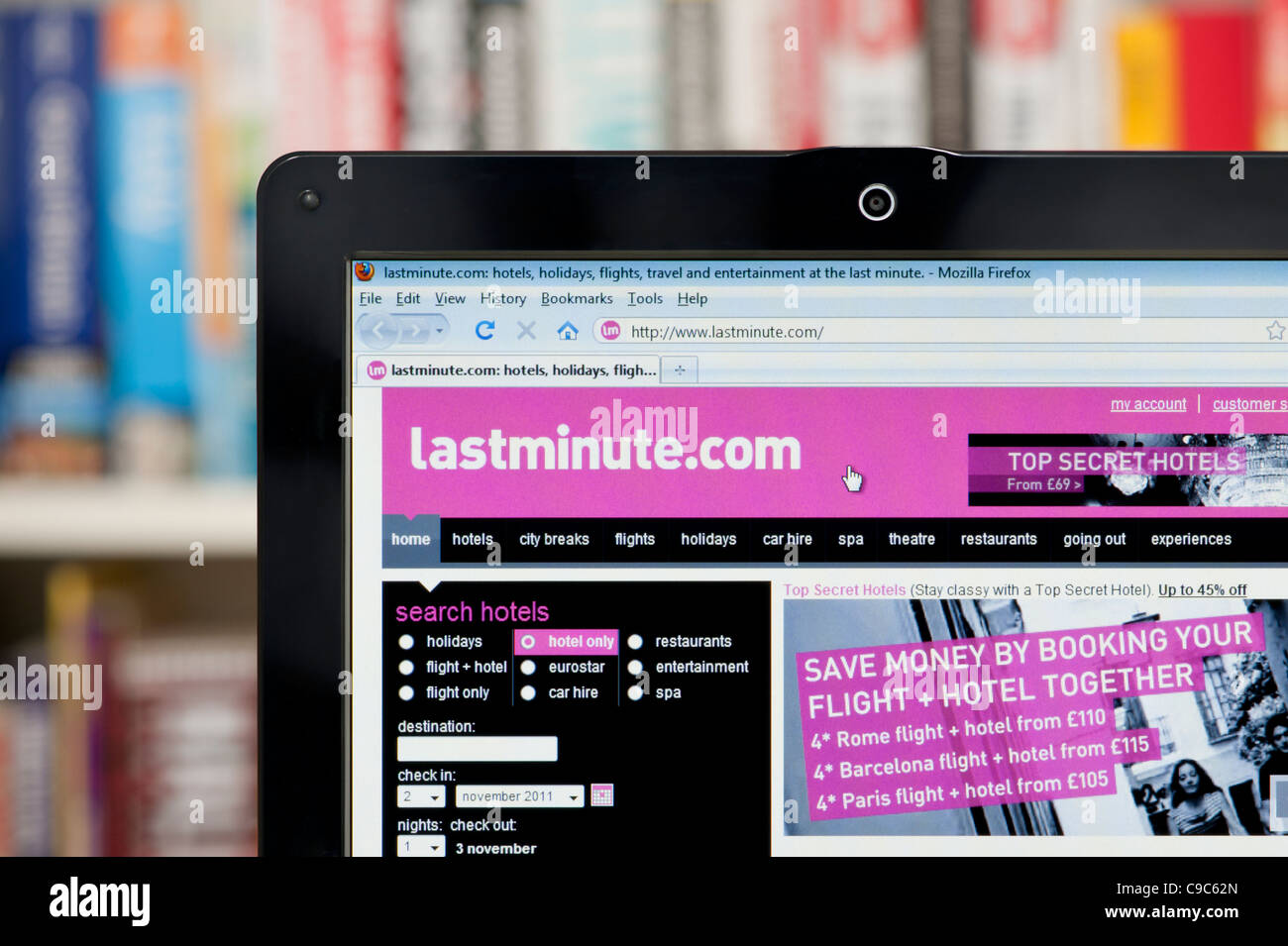 The Lastminute.com website shot against a bookcase background (Editorial use only: print, TV, e-book and editorial website). Stock Photo