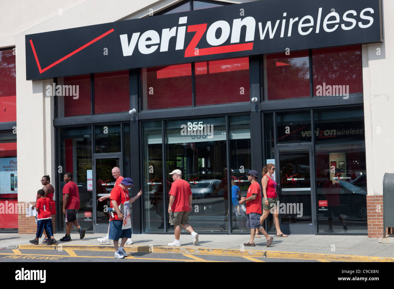 On-strike Verizon employees picket in front of a Verizon Wireless store. Stock Photo
