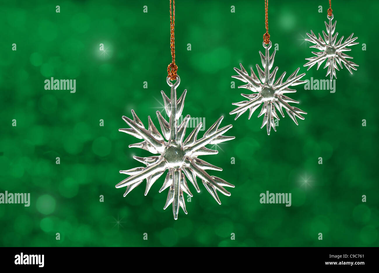 Dreamy image of glass snowflake Christmas ornaments on green background Stock Photo