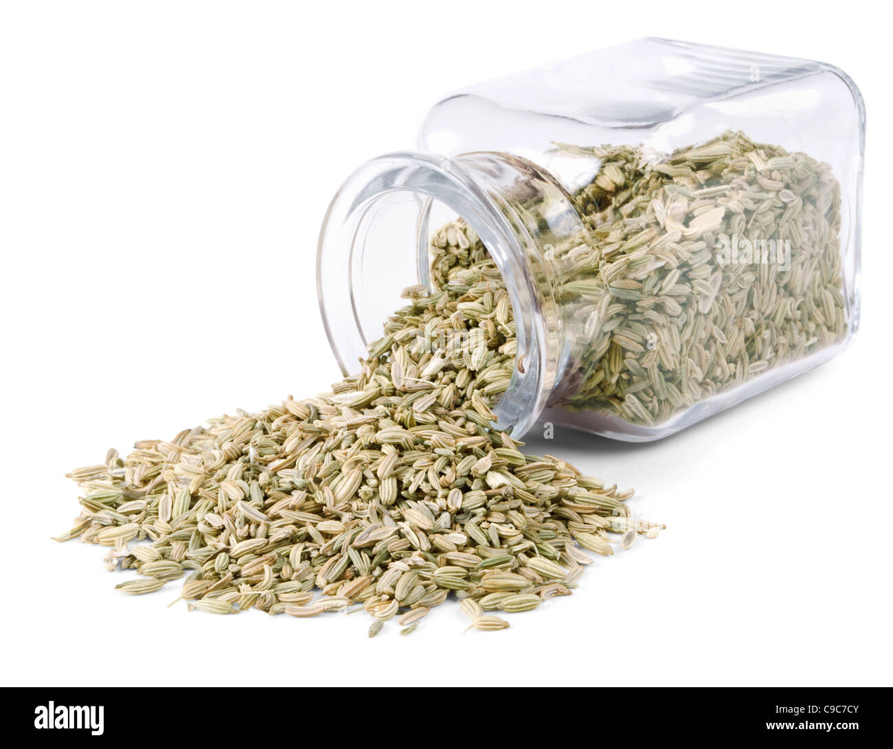 Fennel seeds is scattered on a white background from glass bottle Stock Photo