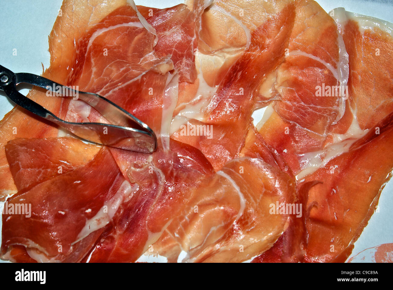 thin sliced Berkel cured prosciutto ham cold cuts appetizer Stock Photo