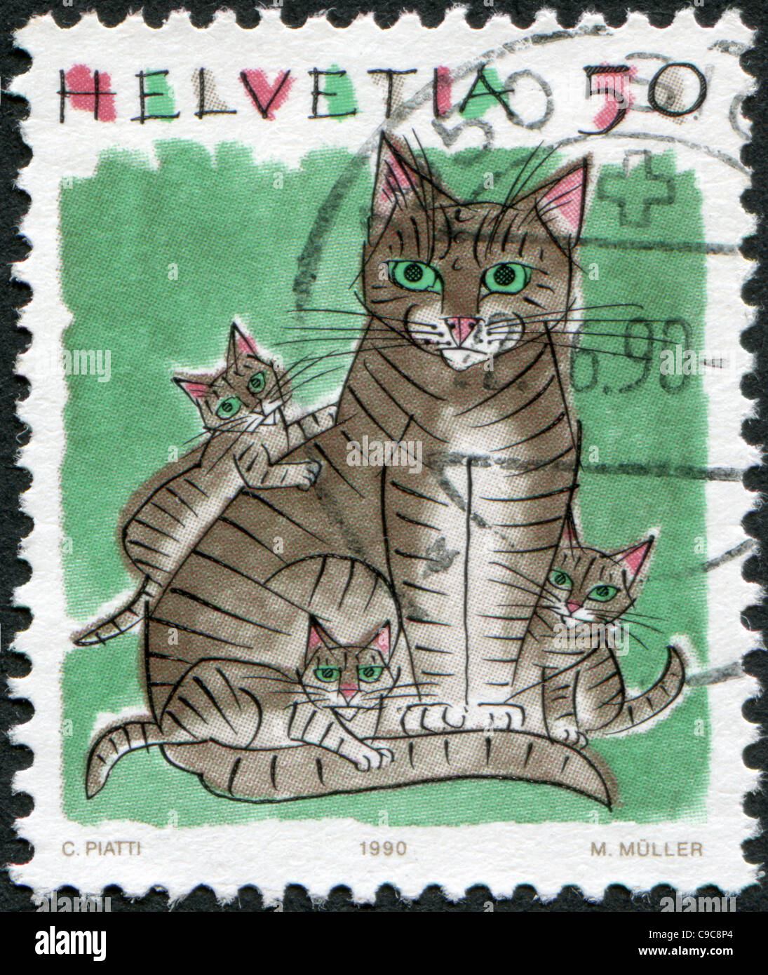 SWITZERLAND 1990: A stamp printed in Switzerland, shows a house cat Stock Photo