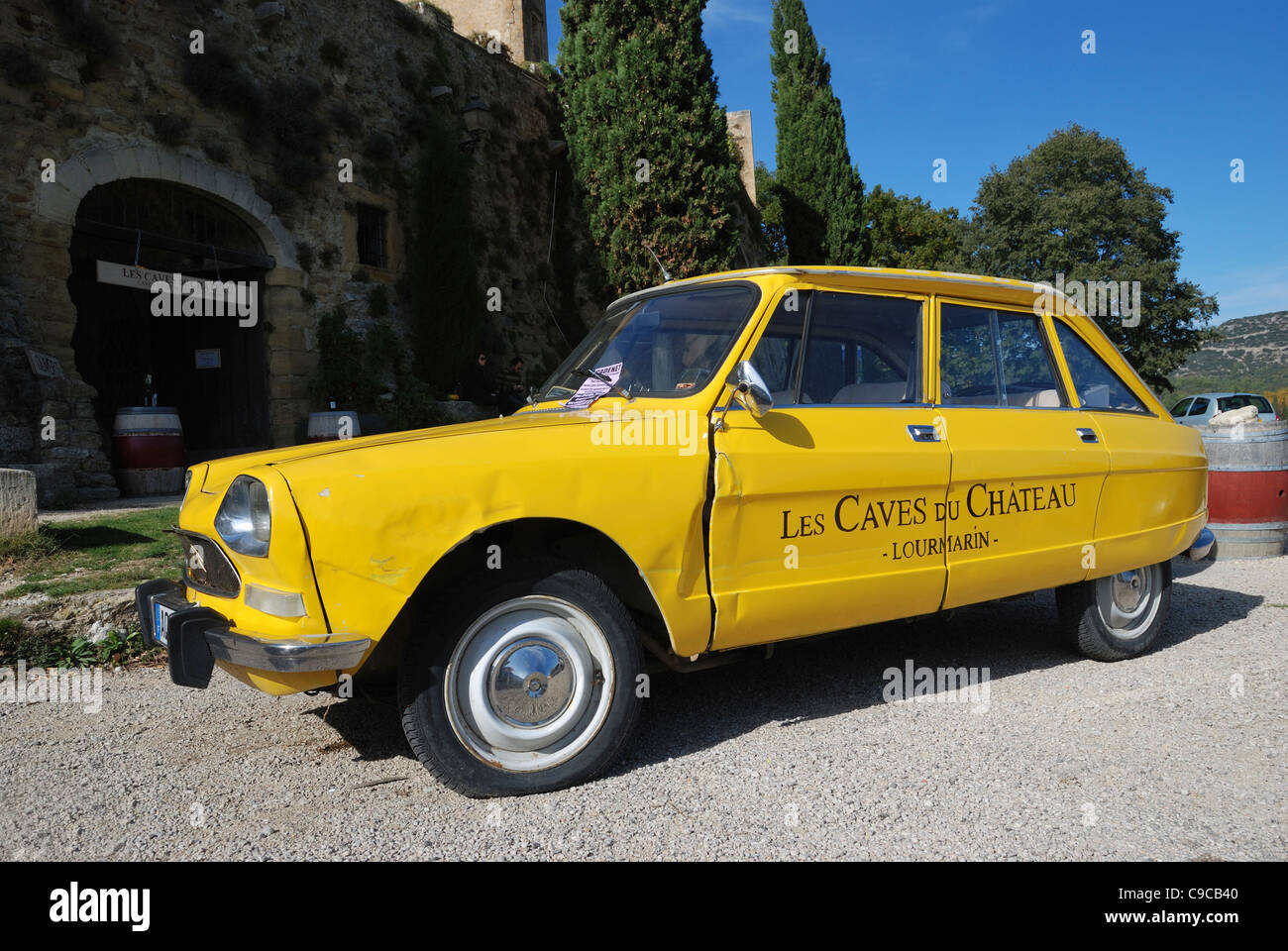 An old  Citroën Ami 8 car used to advertise 'Les Caves du Chateau Lourmarin'. Lourmarin, Provence, France. Stock Photo