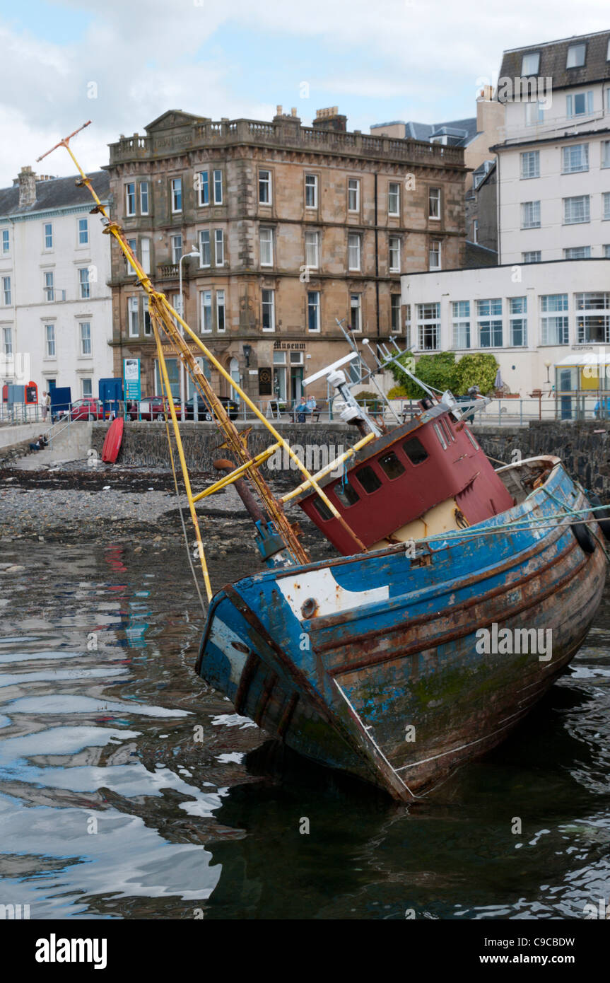 An old fishing boat moored at the quay on the North Pier of the harbour in the middle of Oban, Scotland Stock Photo
