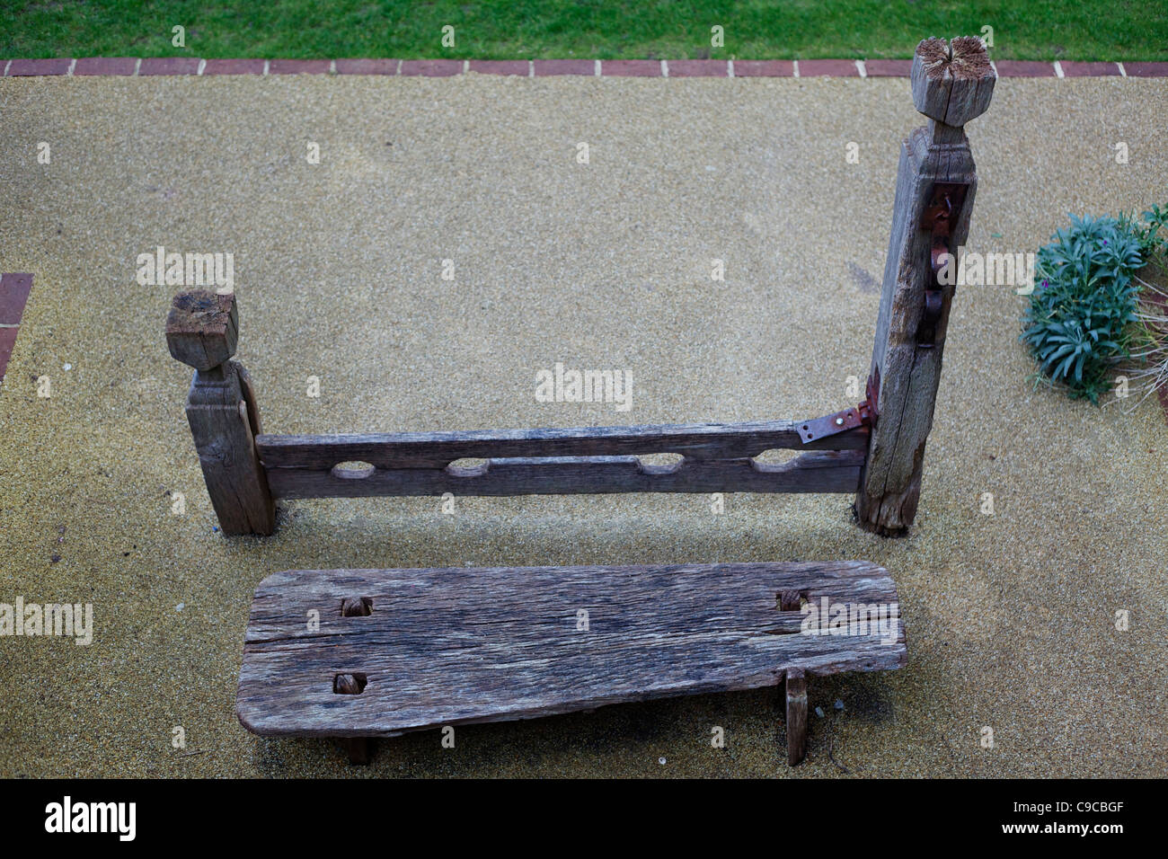Public stocks with seat at Lewes castle Stock Photo