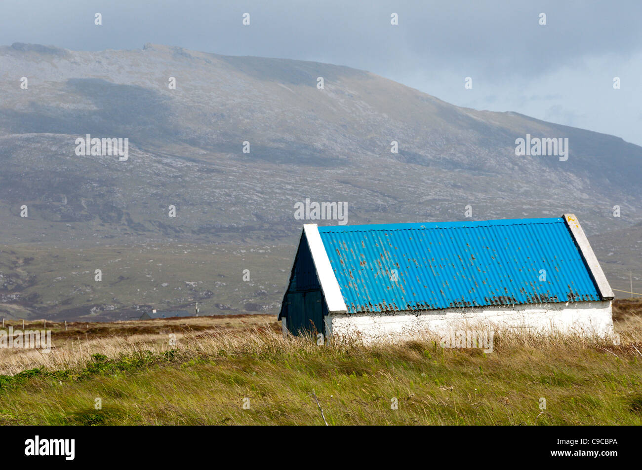 Blue corrugated iron roof on an isolated farm building, South Uist in the Outer Hebrides Stock Photo