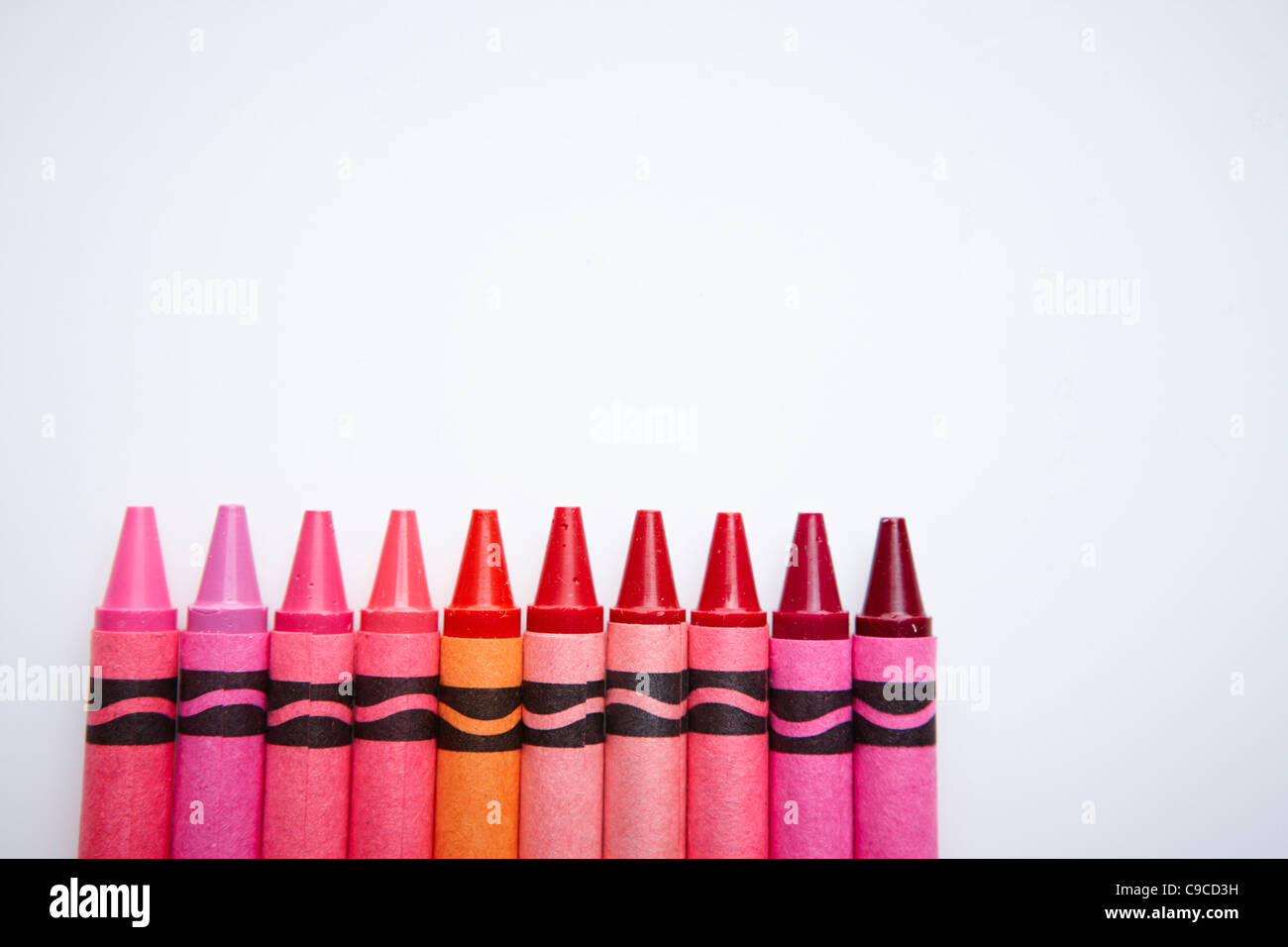 Many crayons in red and pink tone arrayed Stock Photo - Alamy