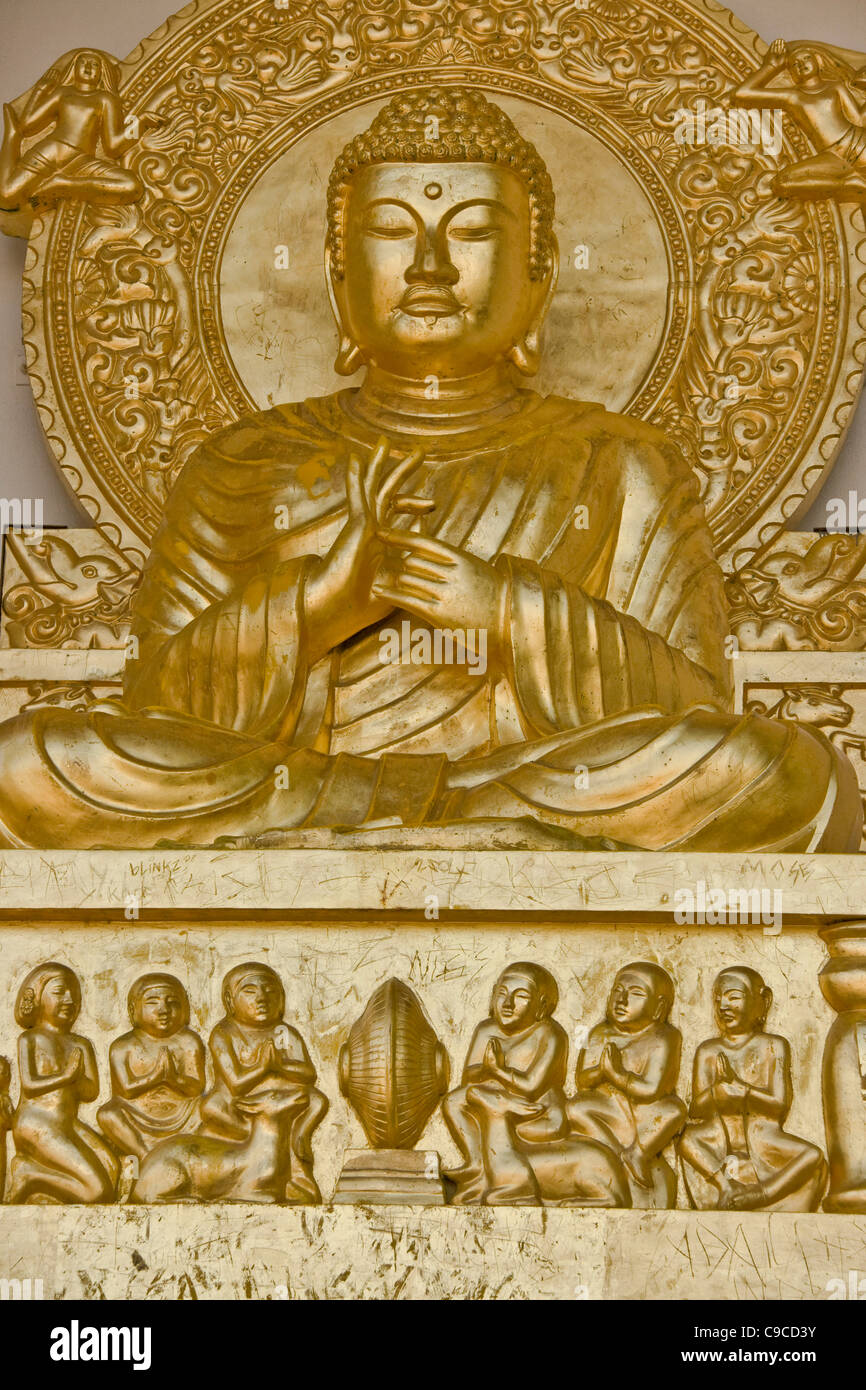 Gold seated Buddha statue and carvings Battersea Park Peace Pagoda London England Europe Stock Photo