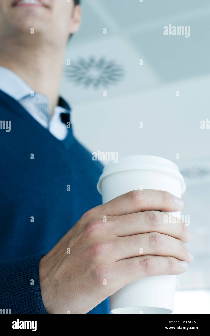 Man holding disposable coffee cup, cropped Stock Photo Alamy