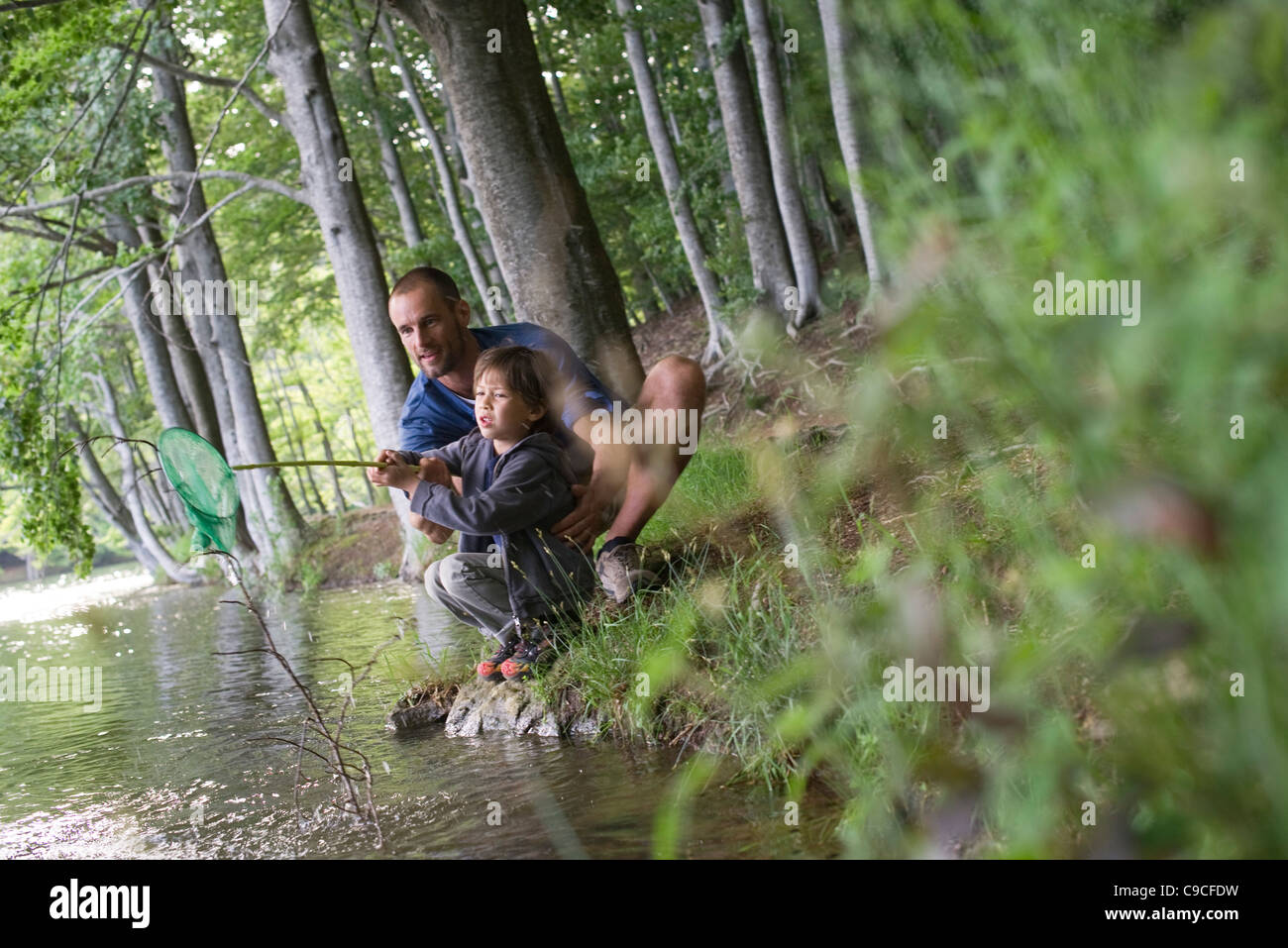 Father and son caught fish in fishing net Stock Photo