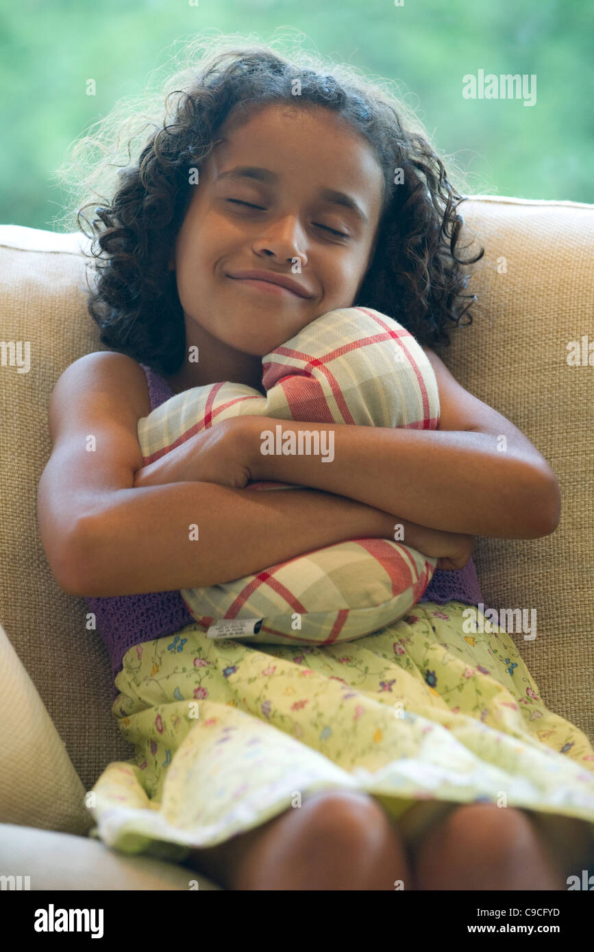 Girl hugging pillow Stock Photo Alamy