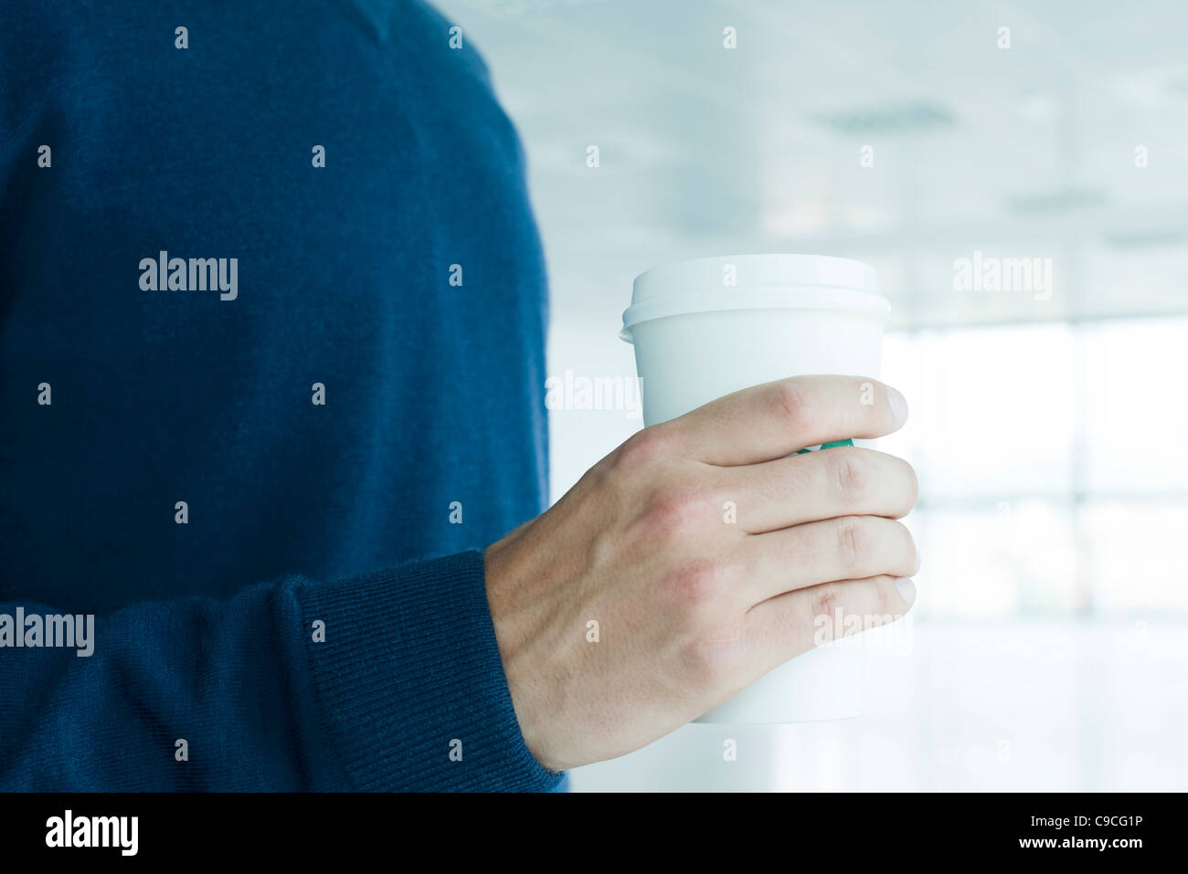 Man holding disposable coffee cup, cropped Stock Photo Alamy