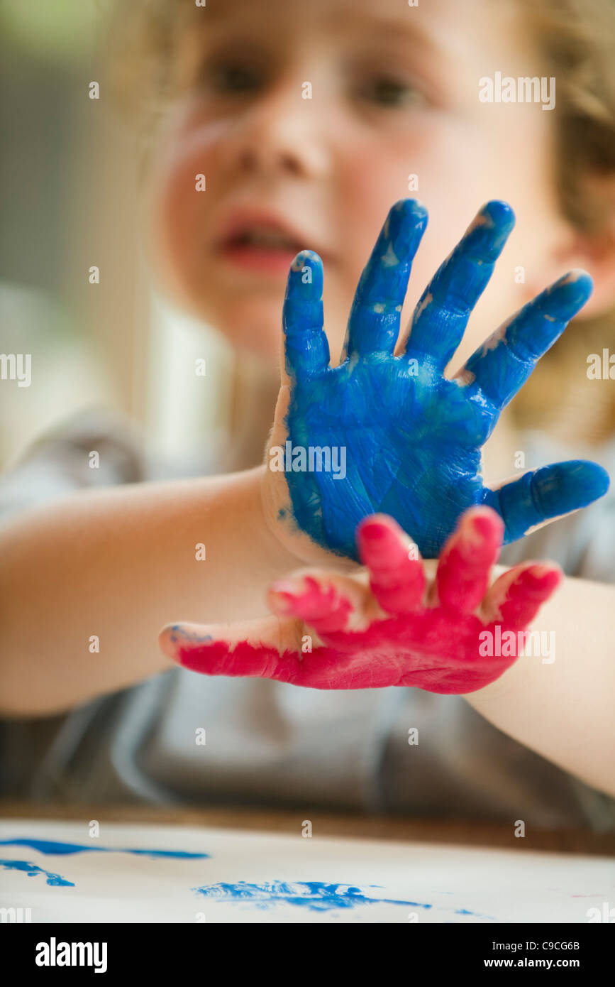 Little boy with hands covered in paint Stock Photo Alamy
