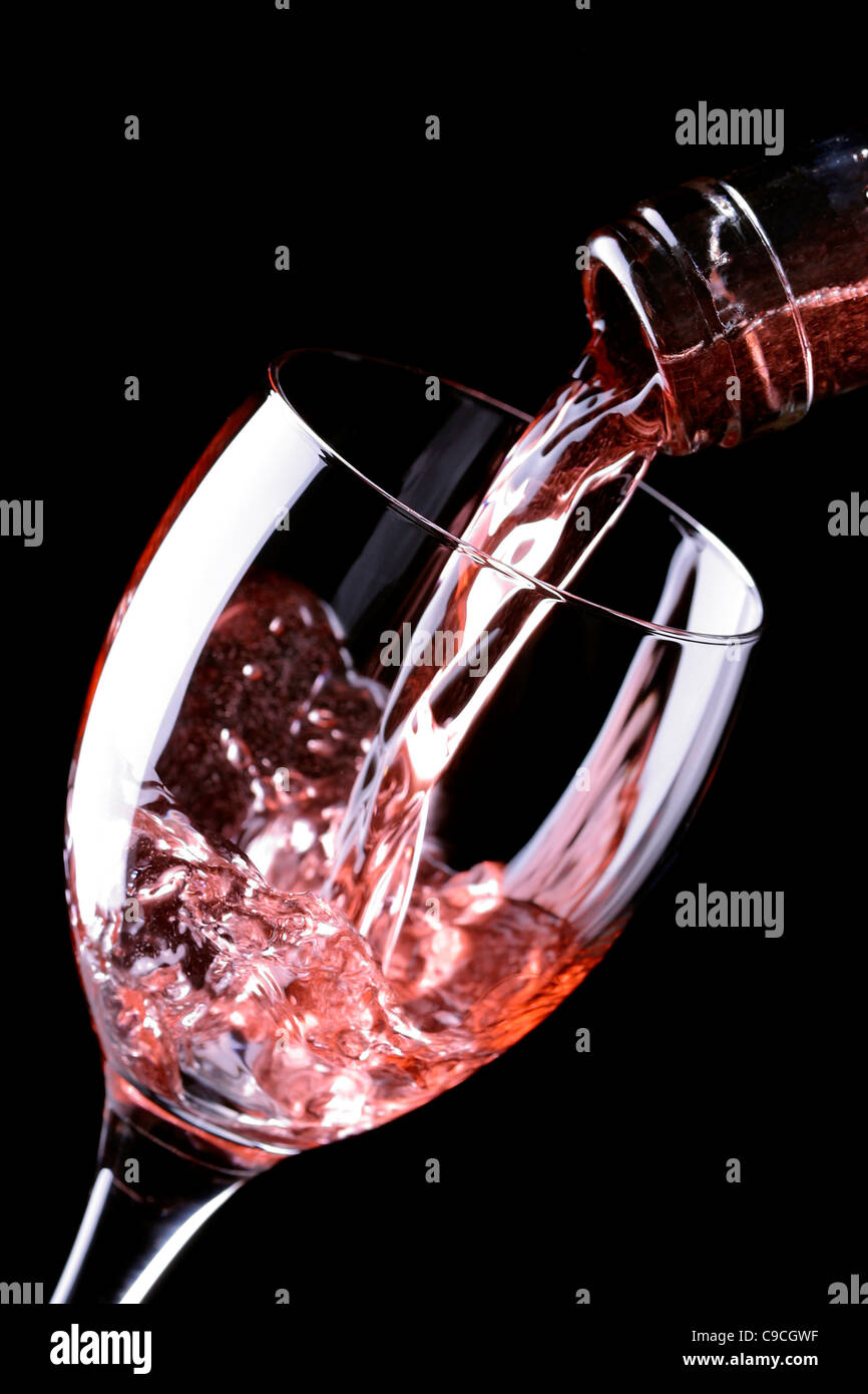 Pouring rosé wine into glass Stock Photo - Alamy