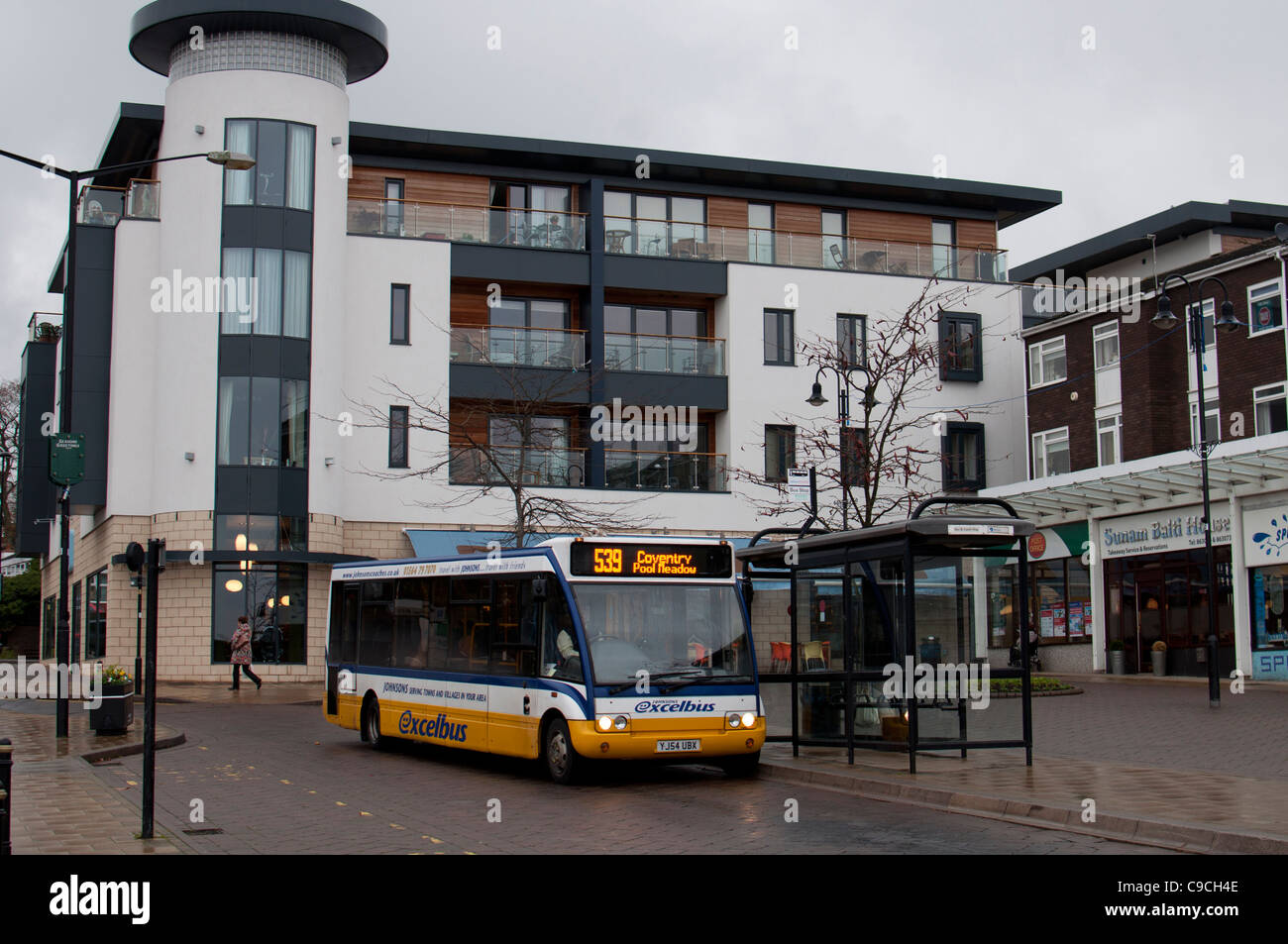 Bus in Kenilworth town centre in dull wet weather, Warwickshire, England, UK Stock Photo