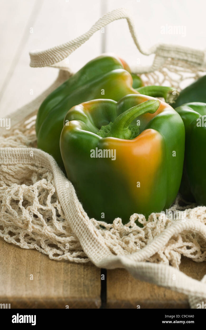 Fresh green bell peppers in mesh shopping bag Stock Photo Alamy