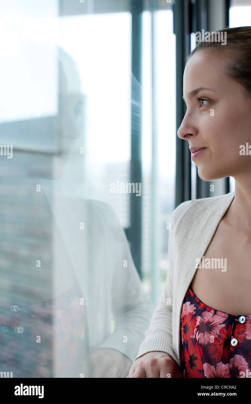 Woman looking out of window, cropped Stock Photo - Alamy