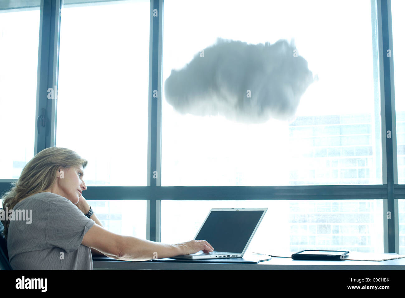 Woman using laptop computer. cloud above laptop computer Stock Photo