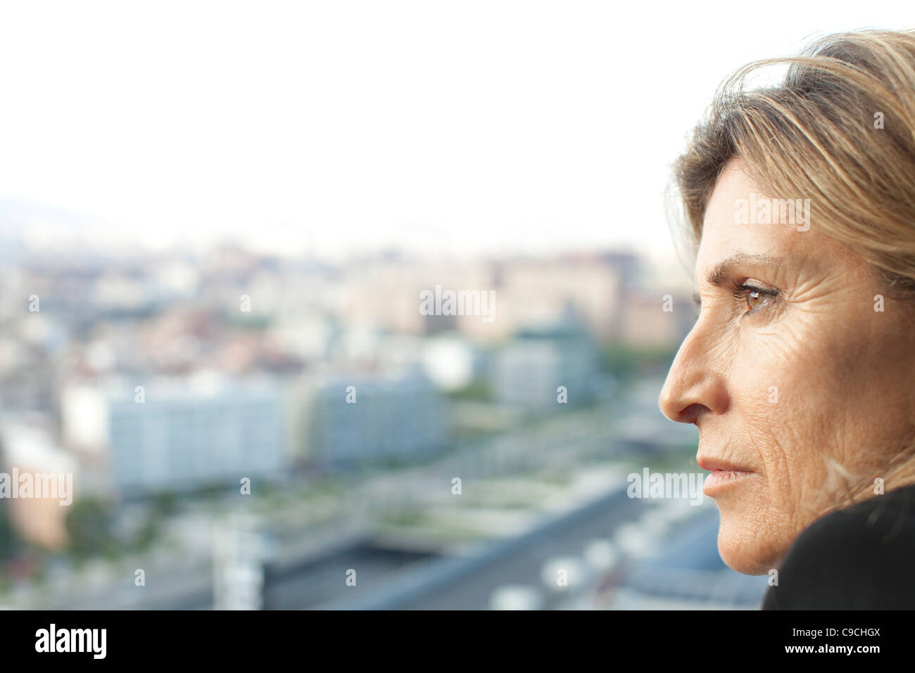 Woman looking at view, side view Stock Photo