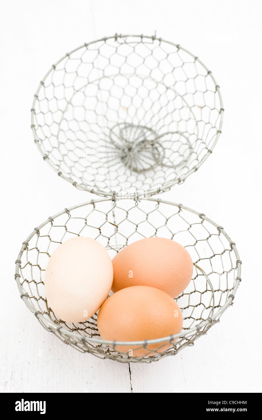 Fresh eggs in wire basket Stock Photo Alamy