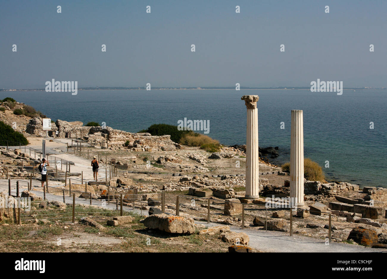 View over the ruins of Tharros and the columns of Tempio Tetrastilo, Sinis peninsula, Sardinia, Italy. Stock Photo