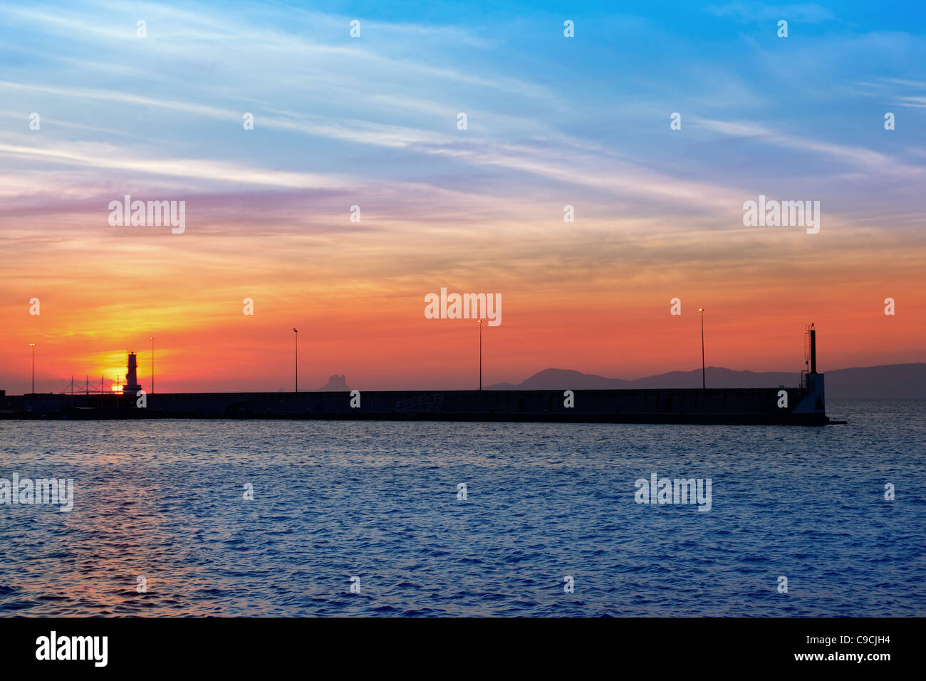Ibiza mountains on red sunset view from Formentera marina Stock Photo