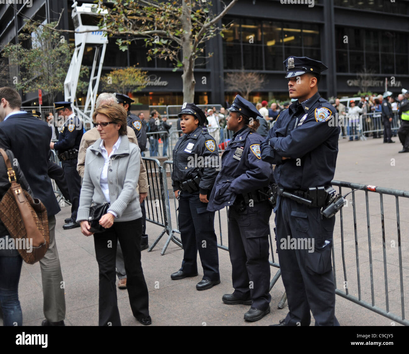 Protesters tourists and police from NYPD at the Occupy Wall Street demonstrations in Manhattan New York USA .  November 2011 Stock Photo