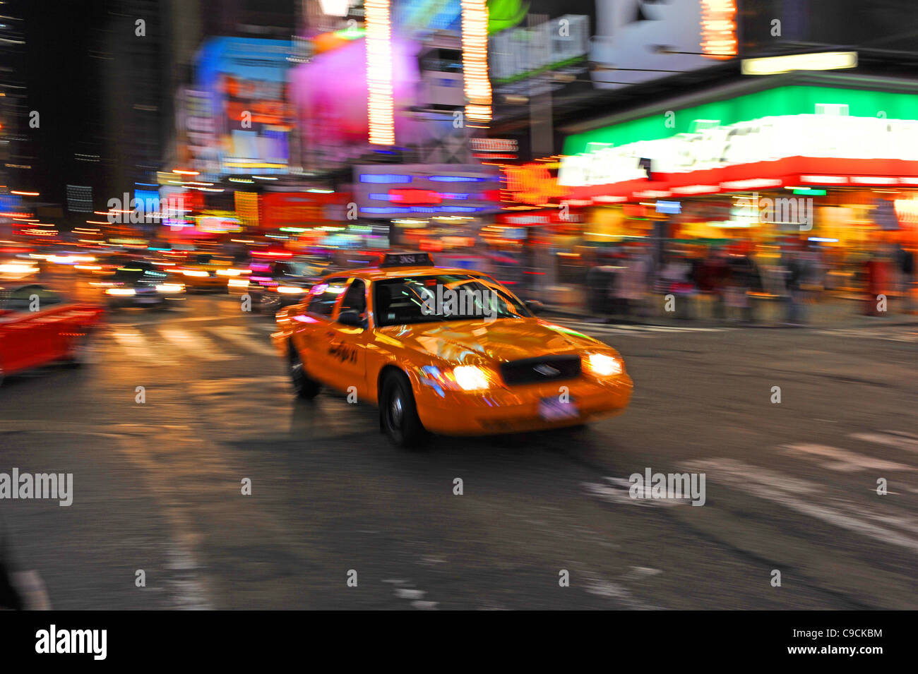 Yellow taxi cab drives through Times Square Manhattan New York NYC USA