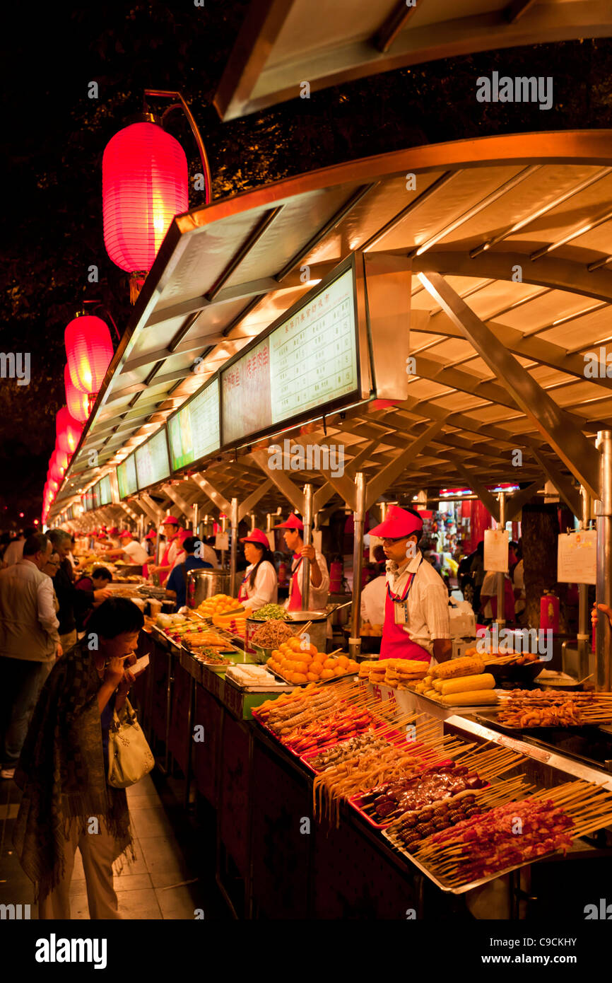 serving exotic food at the Wangfujing night market, Beijing,PRC Peoples Republic of China, Asia Stock Photo