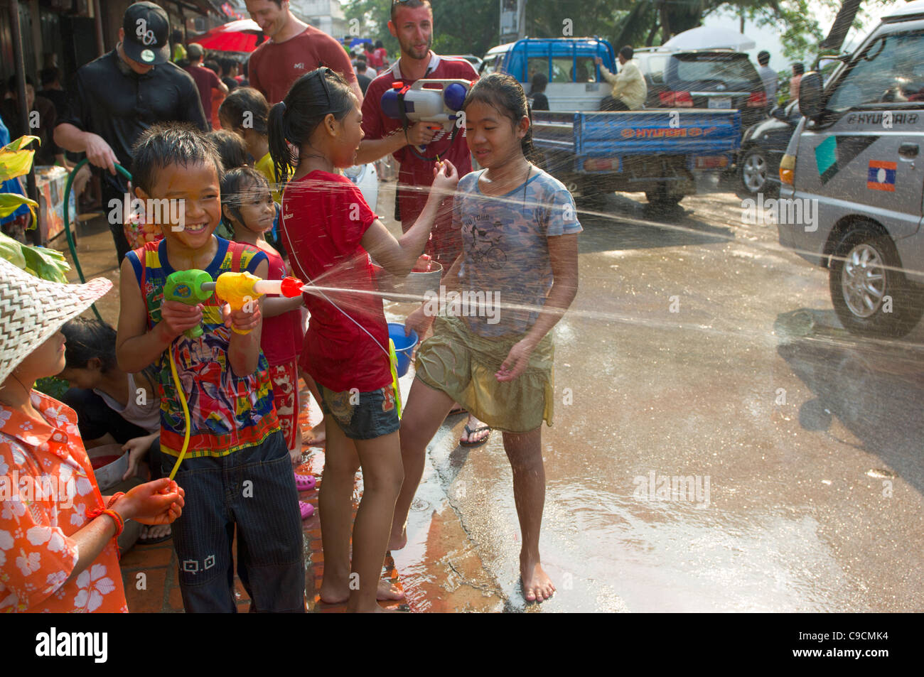 Young Lao boy with super-soaker taking part in waterfights, Lao New Year (Pi Mai Lao), Luang Prabang, Laos Stock Photo