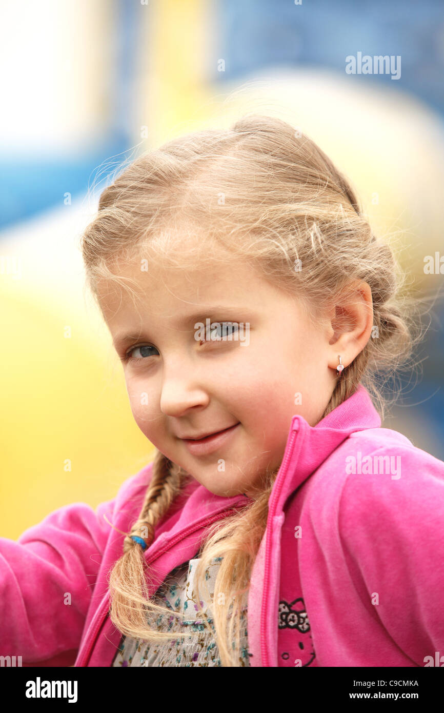portrait of blond girl smiling outside autumn day Stock Photo