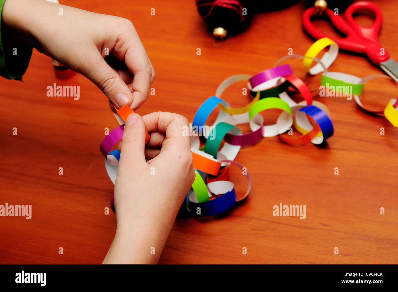 Festive chain of colour paper on the table. Stock Photo