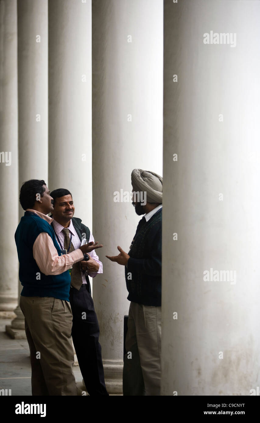 Indian men hold a conversation in Connaught Place, New Delhi, India Stock Photo