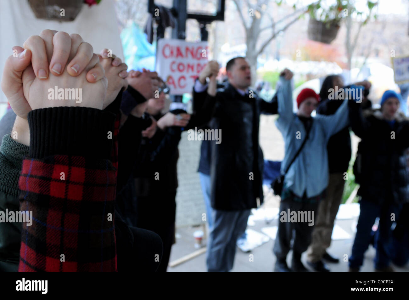 November 21, 2011, this morning Occupy Toronto protesters form a circle and clasp hands at St. James Park following a decision handed down earlier today by Ontario Superior Court judge David Brown, upholding the Occupy Toronto tent camp eviction. Stock Photo
